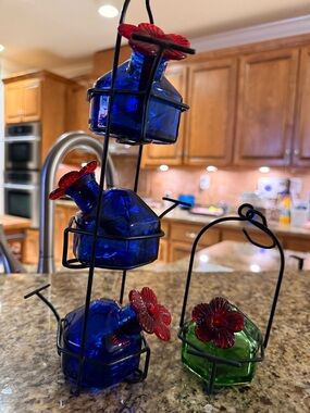 Blue and Green Glass Hummingbird Feeders with Red Flower Tops